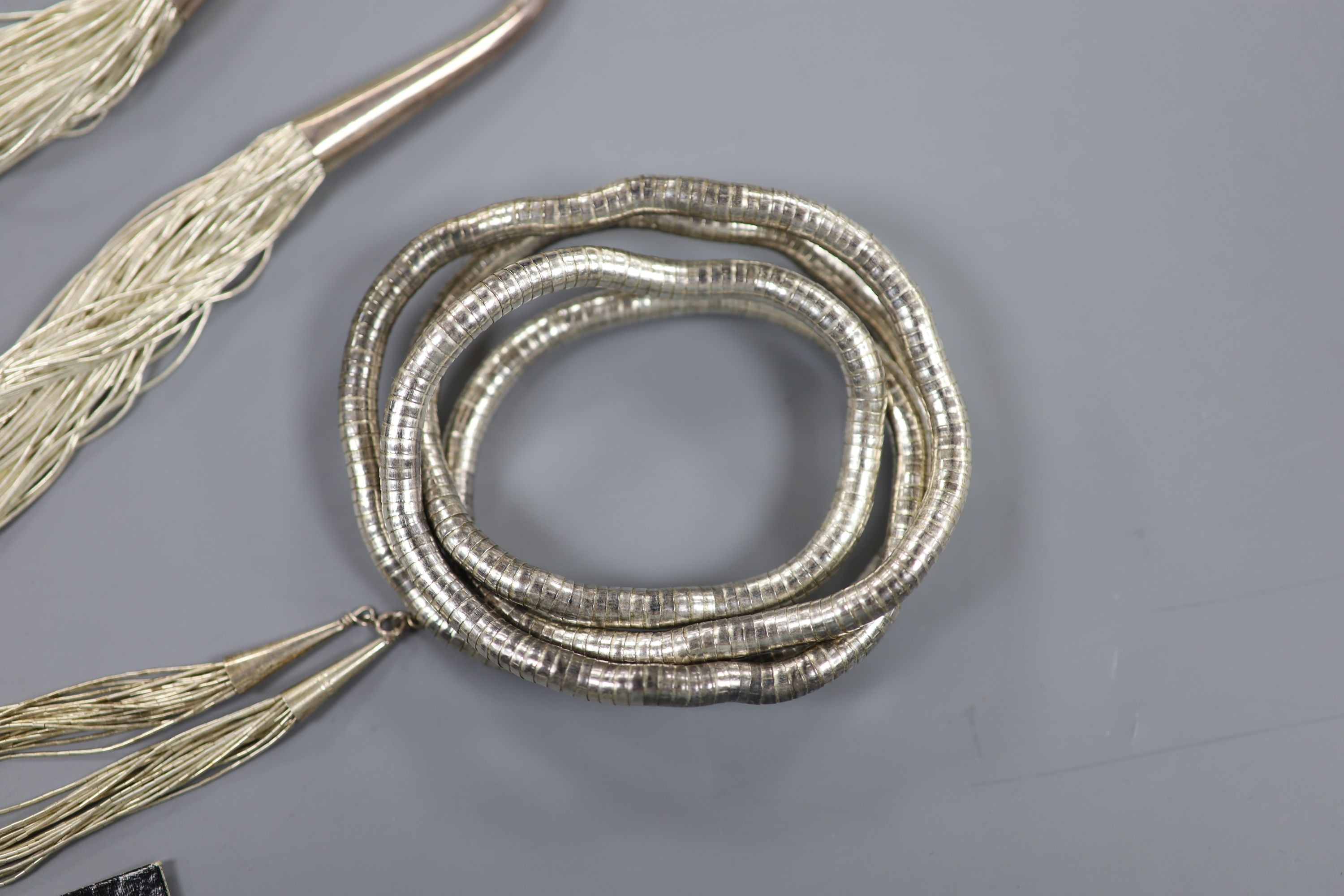 A modern sterling mounted torsade necklace, approx. 58cm, with matching bracelet and earrings and a metamorphic bangle?